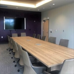 A room with a wooden table and chairs