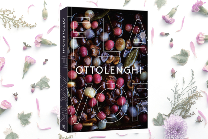 Book cover shows title FLAVOR and author last name OTTOLENGHI against a sea of roasted onions in various colors: yellow, rose, red/purple, all on a black background. Bordering the book cover is a white background strewn with flower buds: carnations and others.