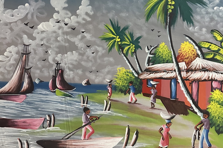 Painting of people working and walking around the coastline of Haiti. Sailoats and palm trees surround people wearing blues and reds and a red house with a thatch roof.