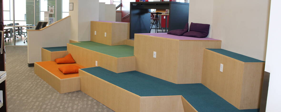 Large blocky and uneven steps with green, orange, blue, and purple carpeting.