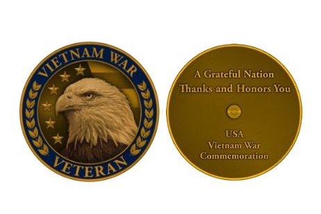 Side of of a round graphic shows the head of an american eagle Vietnam War Veteran. Side two words only A Grateful Nation Thanks and Honors You