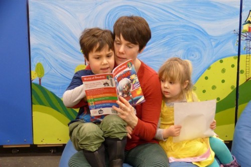 Family reads together in the Kid's Room