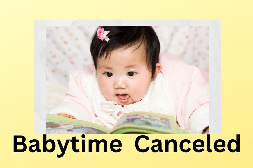 infant laying on tummy looking at book