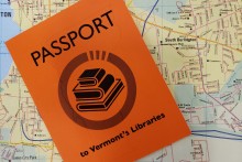 Library passport on top of Vermont Map